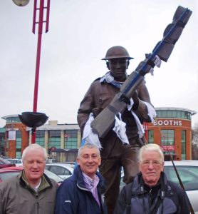 Chorley Pals statue arrives in Chorley on 25 February 2010. L–R: Steve Williams, Lindsay Hoyle and John Garwood